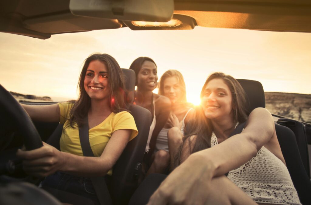 amiche sedute in auto noleggiata in partenza per un viaggio 
